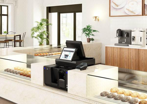 Sistema Glory integrato nel punto cassa di un caffè